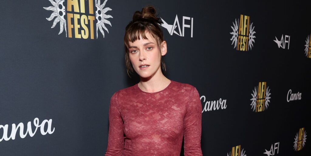 Kristen Stewart wears a burgundy fitted lace dress