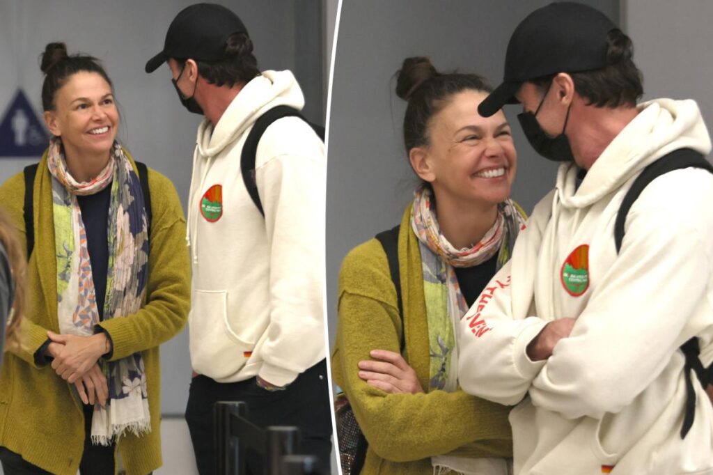 Hugh Jackman and Sutton Foster look more in love than ever as they arrive at LAX