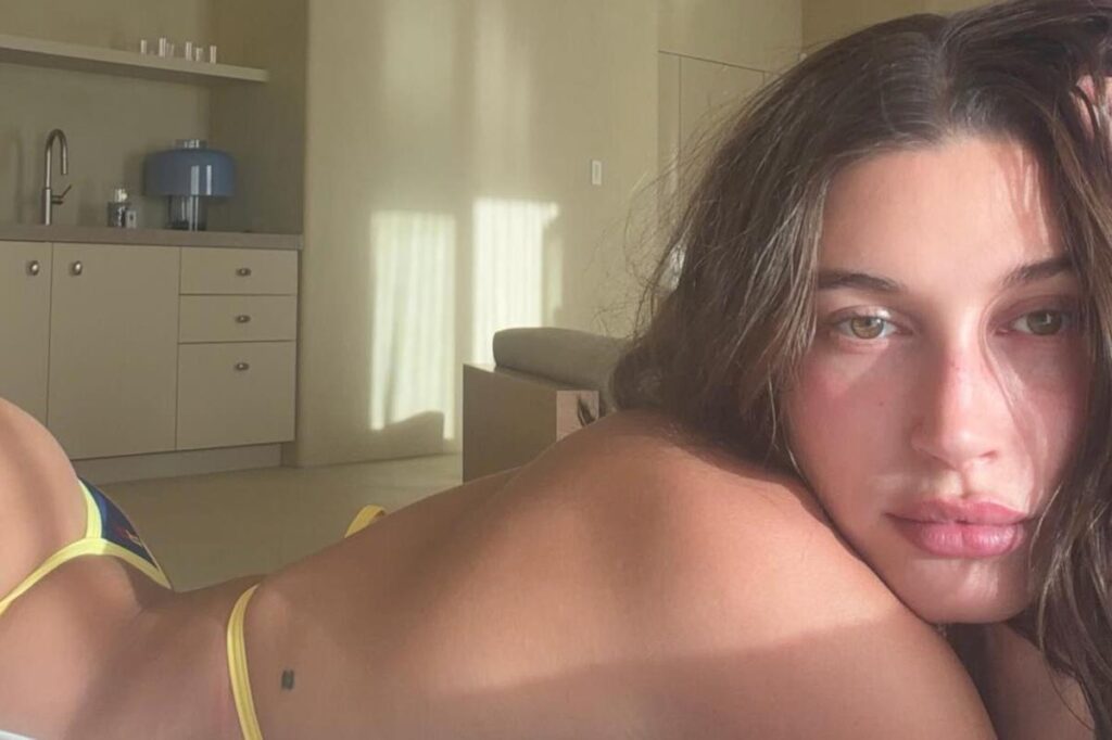 Cheeky Hailey Bieber shows off her yellow thong bikini while relaxing at her mansion