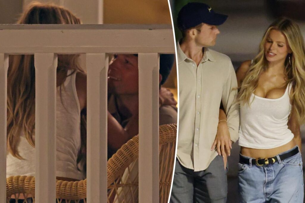 Taron Egerton can’t keep his hands off Brooks Nader during their steamy beachside date