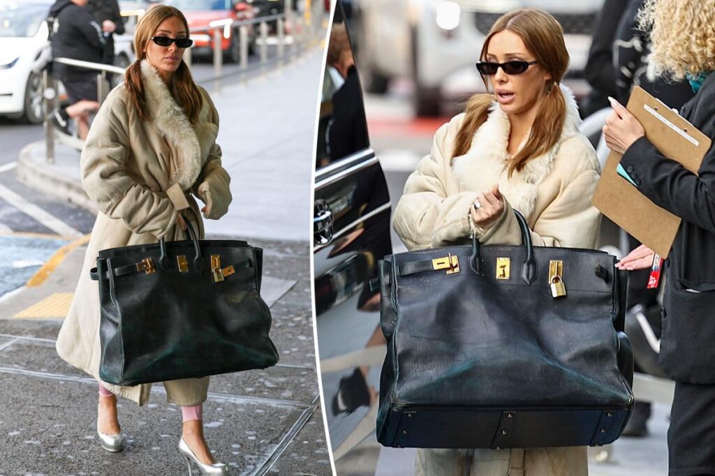 Bianca Sensoroli carries a giant Hermès Birkin bag at Melbourne Airport